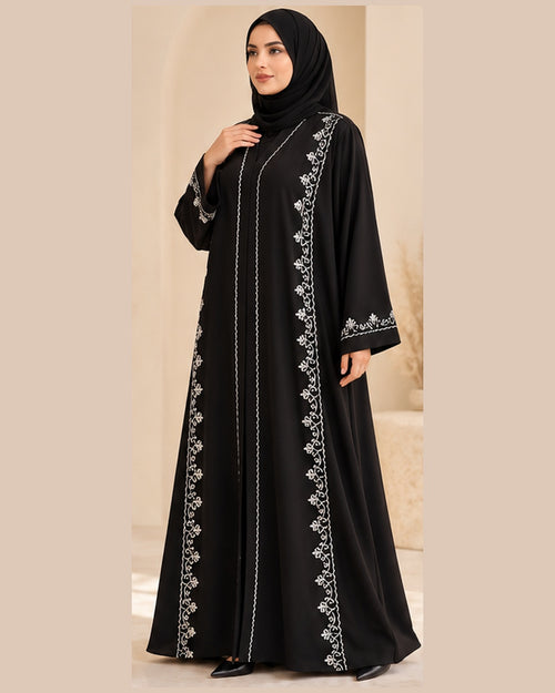 Black abaya three-quarter view with white vine trim