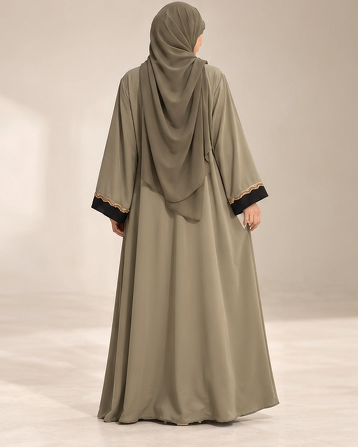 Olive abaya with black center panel and gold trim back view