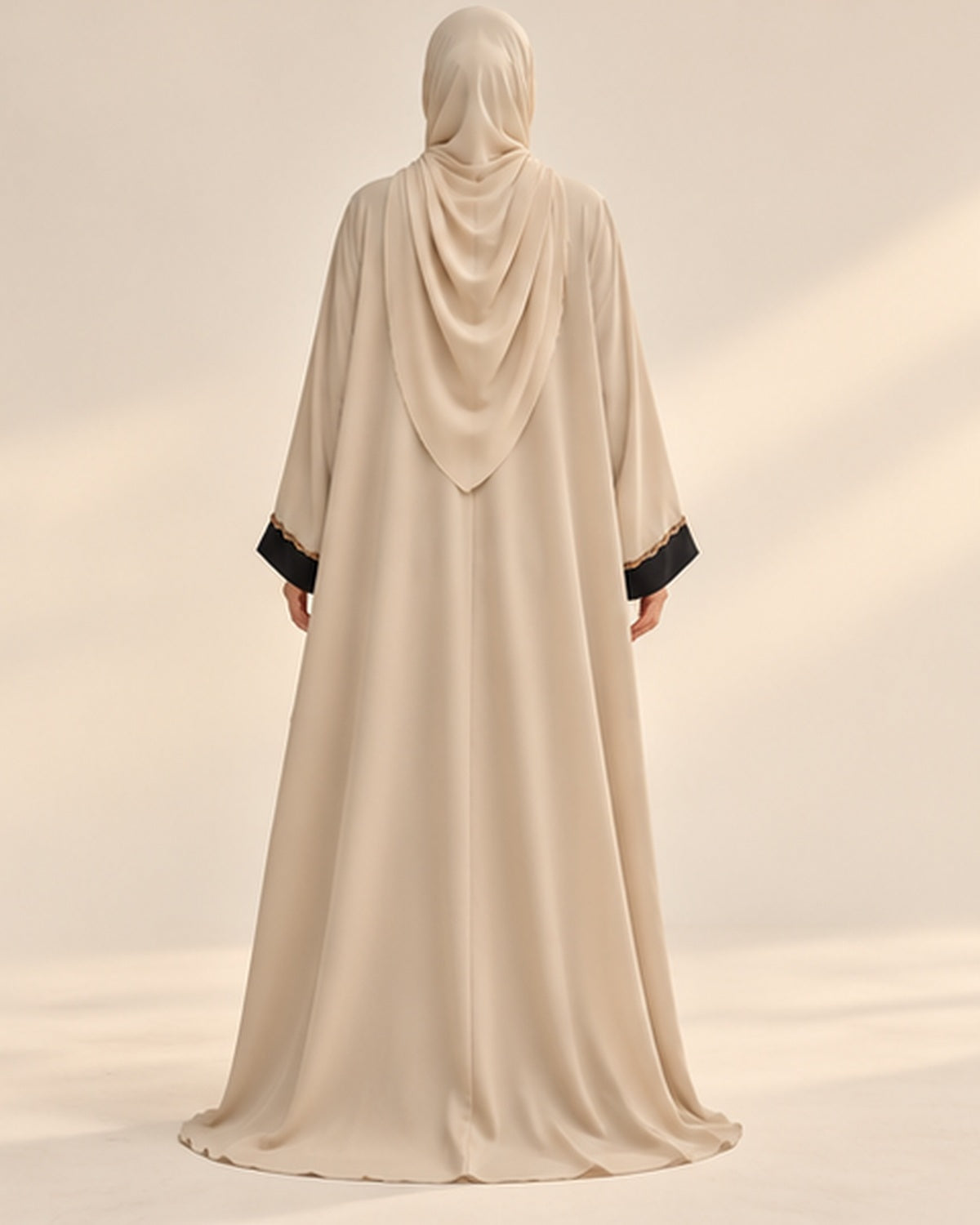 Cream abaya with black and gold pendant trim back view