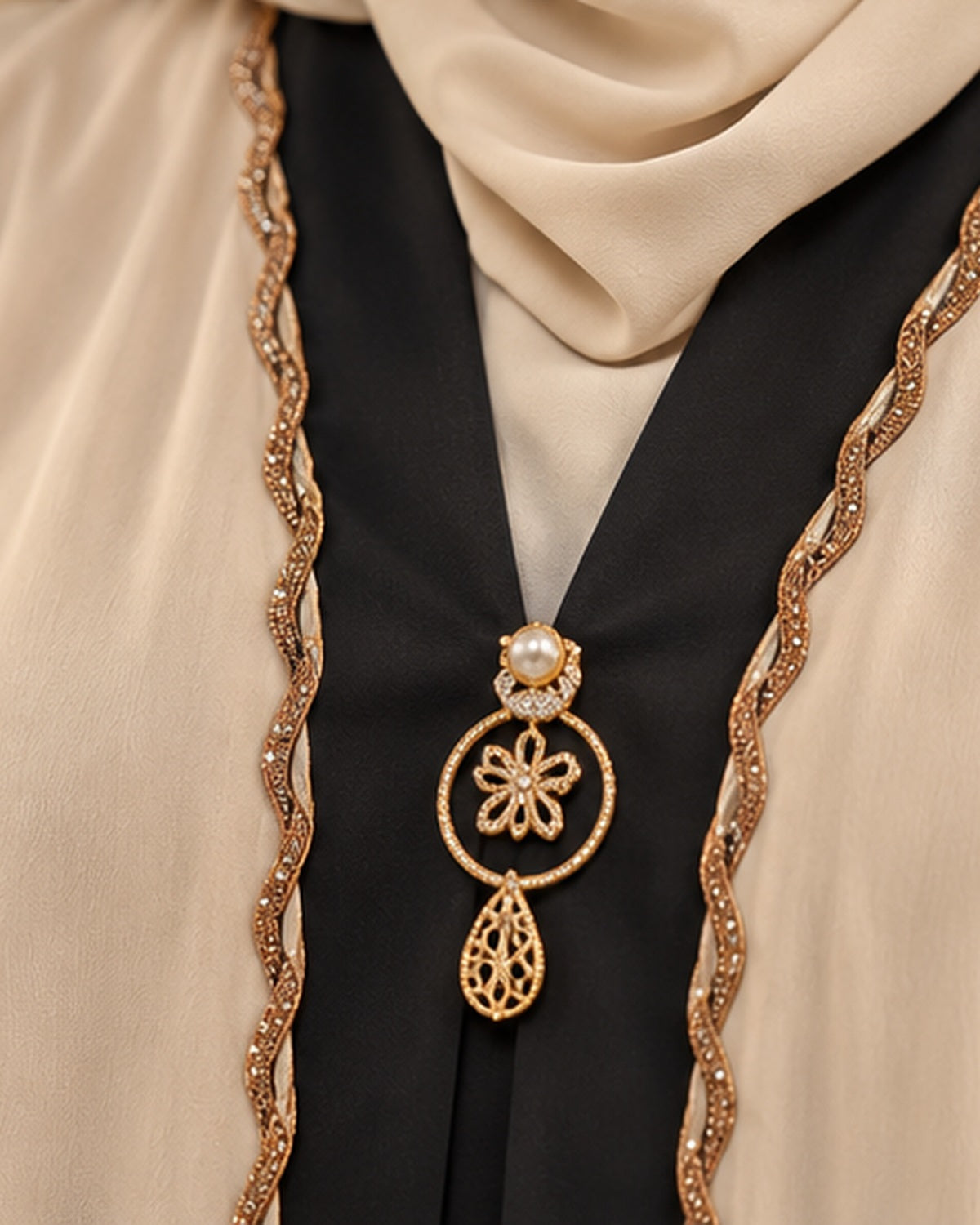 Cream abaya black and gold pendant neckline detail